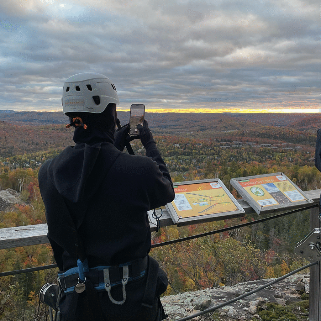 ziplining in nature taking a pictuxre of the tarting sunset
